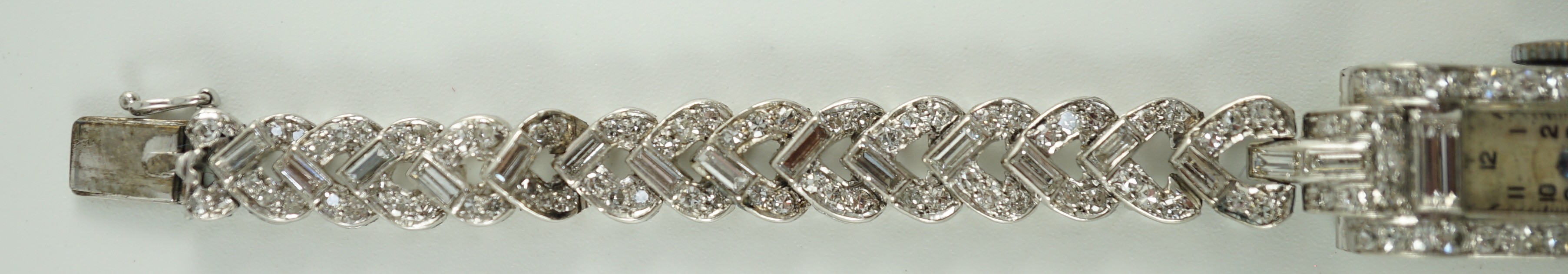 A lady's 1930's/1940's platinum, baguette and round cut diamond set rectangular dial manual wind cocktail watch, on a white gold and baguette and round cut diamond set bracelet, with Asprey box